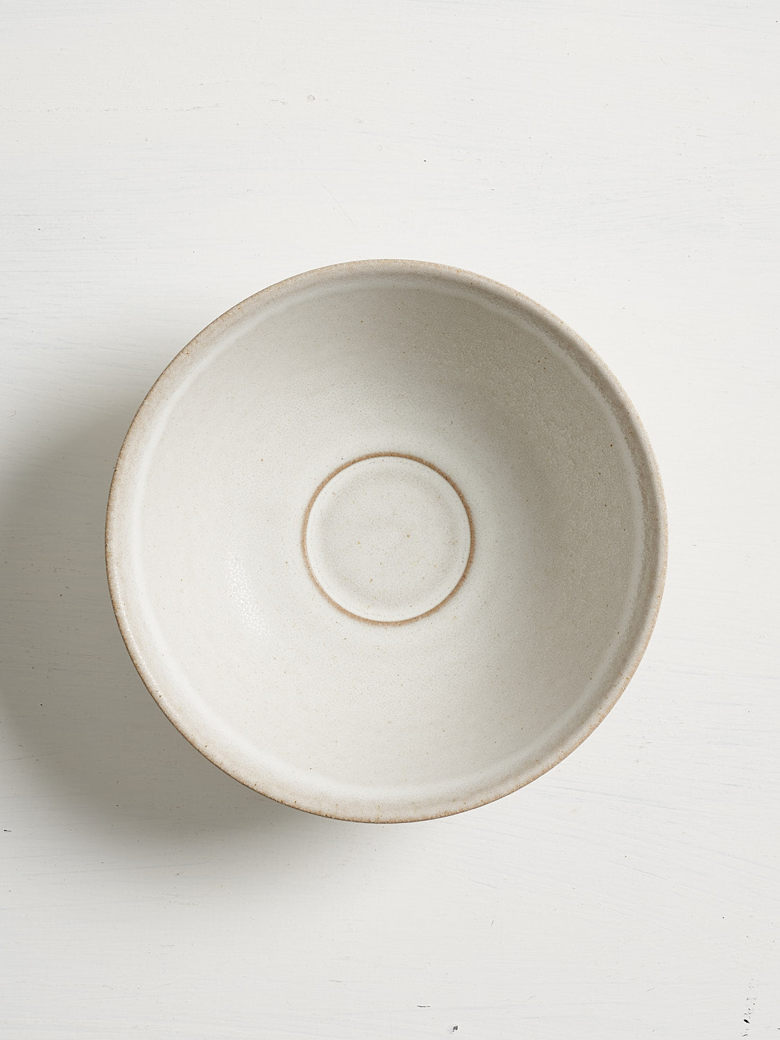 A white ceramic bowl for soups and cereal on a white background