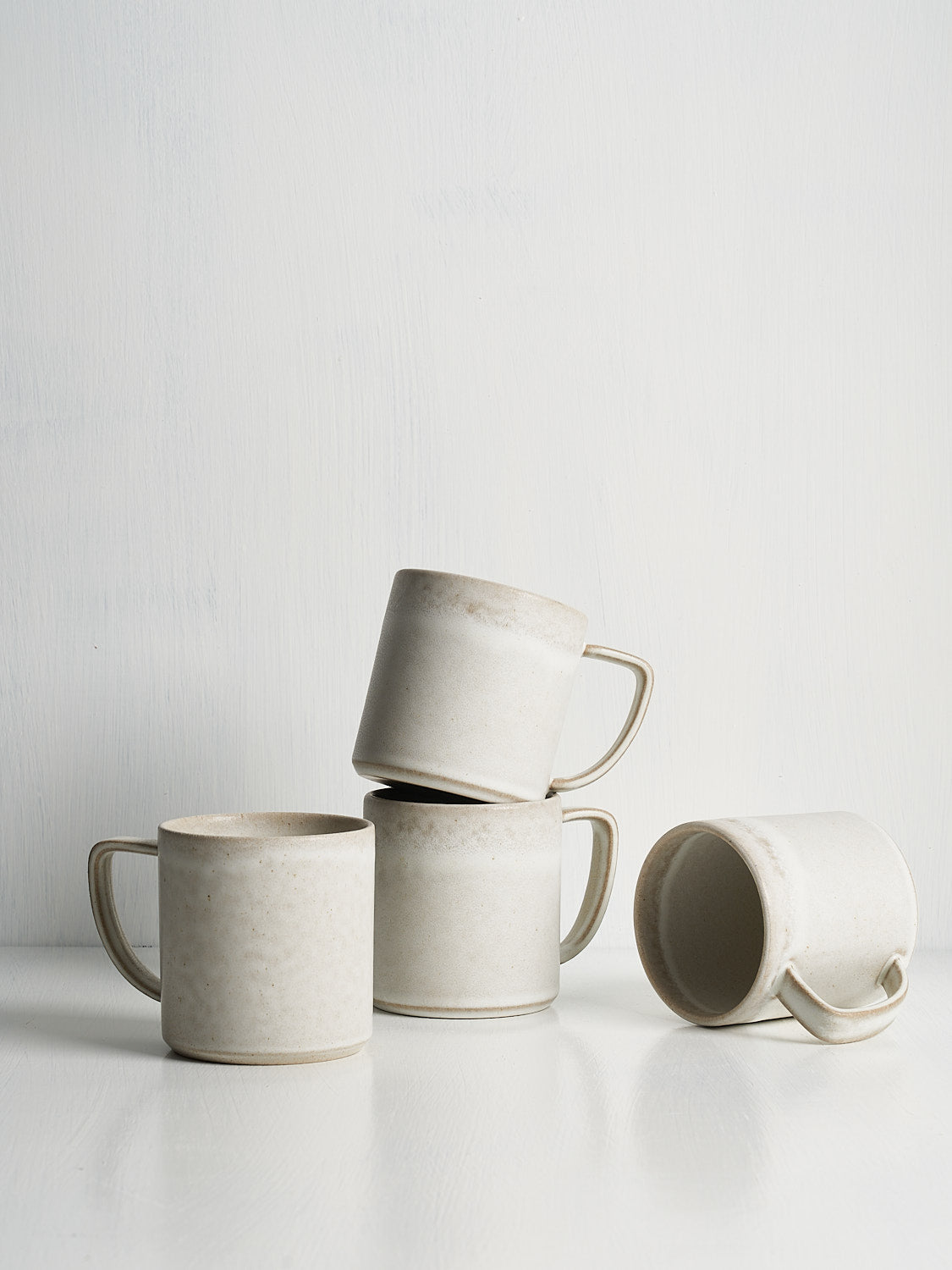 Stoneware mugs with minimalist lines and semi-matte glaze, made in Portugal.