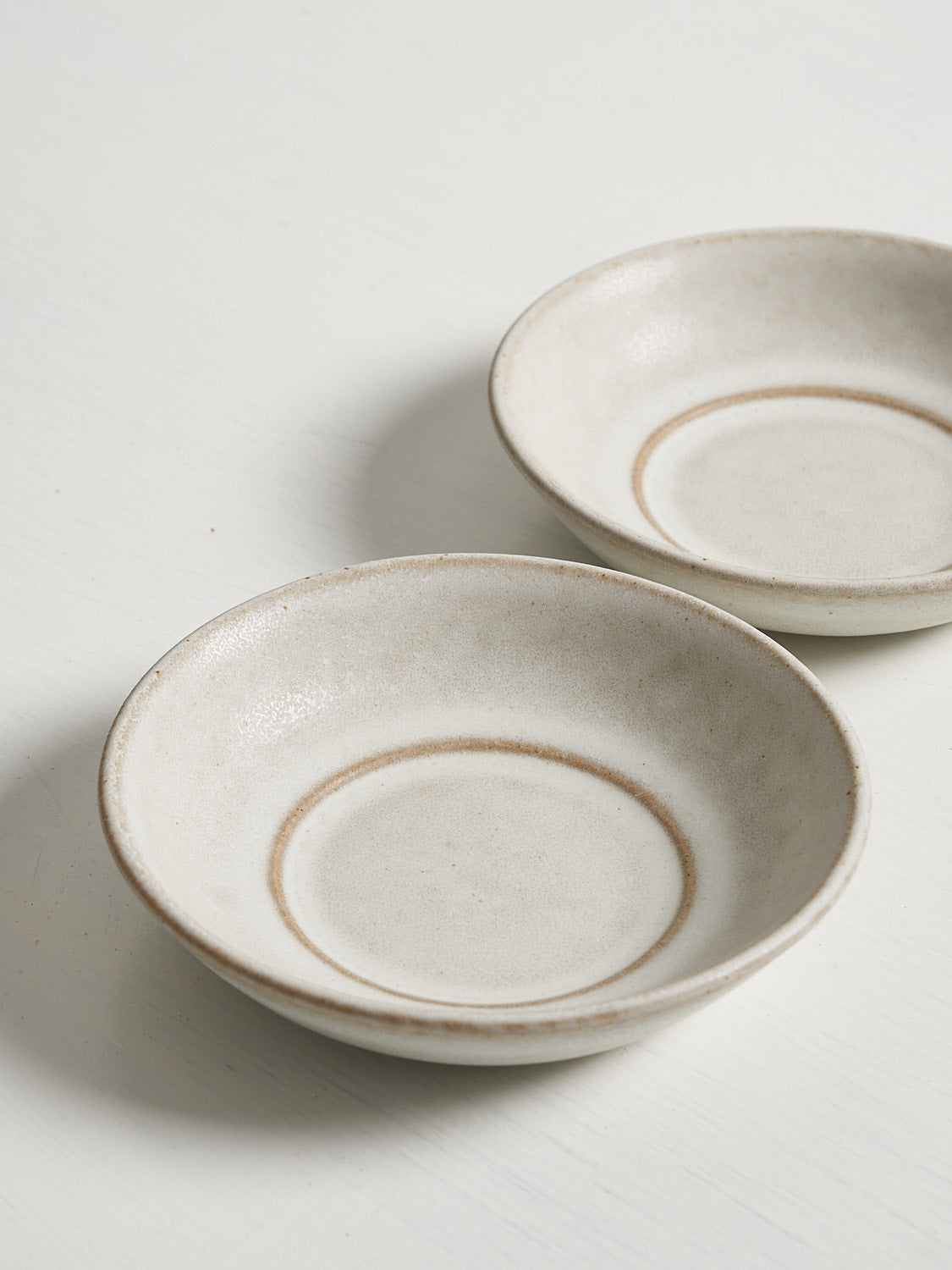 Petite stoneware dishes designed for small bites and tabletop accessorizing